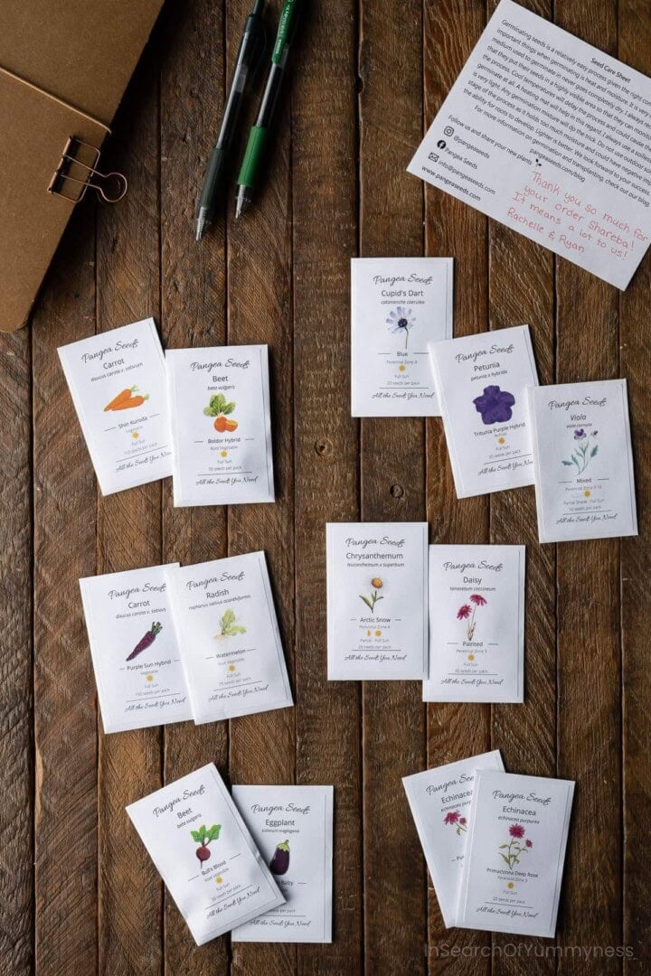 Tiny seed packets from Pangea Seeds with illustrations of vegetables and flowers on them.