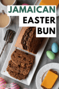 A white platter with slices of freshly baked Easter Bun, next to a saucer with slices of cheese. Text overlay says "Jamaican Easter Bun".