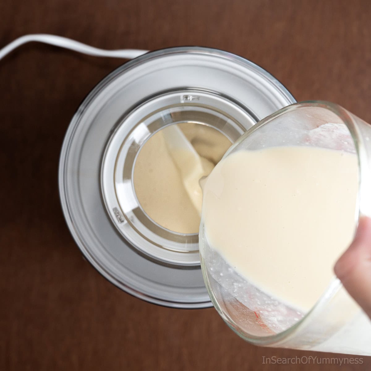 Pouring ice cream mixture into an ice cream machine.
