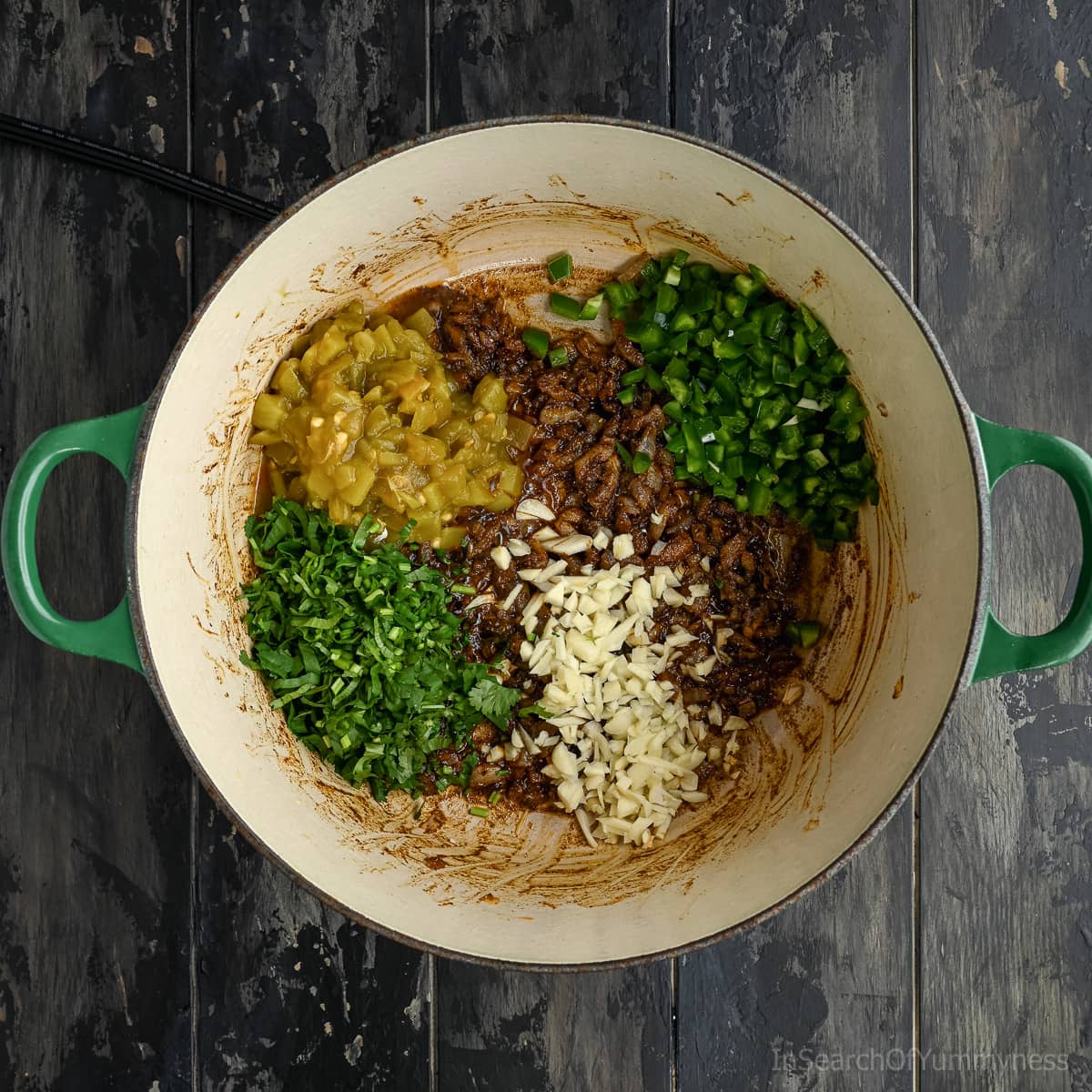 Sauteed onions and spices with canned green chlies, jalapeno peppers, finely chopped cilantro and finely chopped garlic in a Dutch oven.