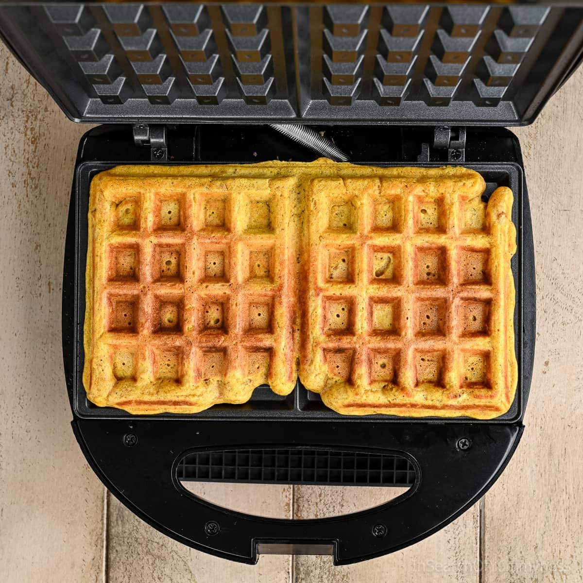 Cooked pecan pumpkin waffle in an inexpensive Mastercraft waffle maker.