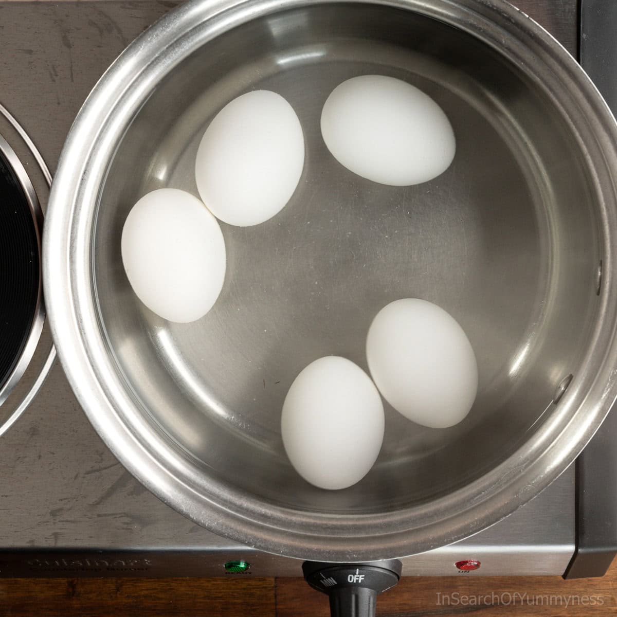 5 large eggs in a bot of boiling water on the stove.
