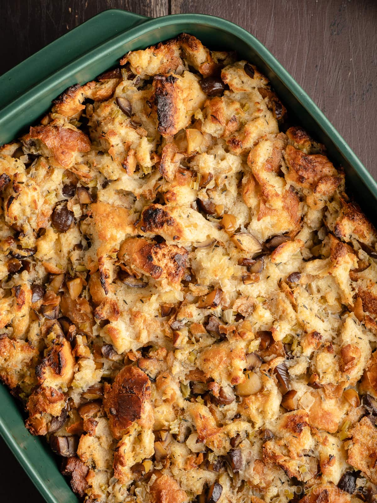 A close up view of baked chestnut stuffing with a crispy golden brown top.